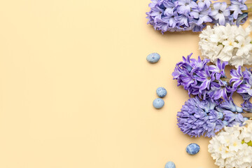 Beautiful hyacinth flowers and Easter eggs on beige background