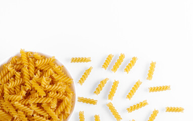 Pasta products in the form of a spiral on a plate, texture, on a white background