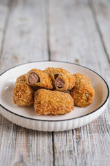 sausage roll on the wooden table
