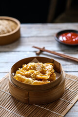 spring rolls , dim sum in bamboo basket