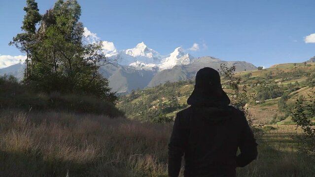 close up of walking feet, tilt up to wide mountain landscape of Huaraz, Yungay, Peru.
