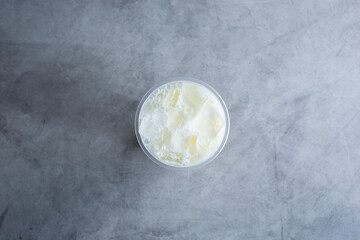 A top down view of a mango milk tea beverage.