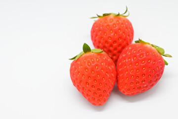 beautiful three fresh red strawberry isolated on white background