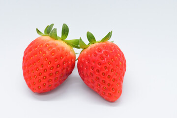beautiful two fresh red strawberry isolated on white background