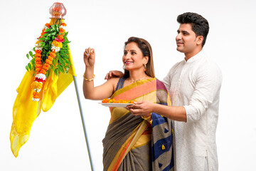Indian Couple performing or celebrating Gudi Padwa Puja. celebrating marathi new year.