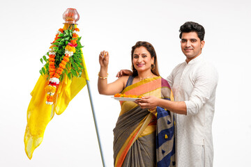Indian Couple performing or celebrating Gudi Padwa Puja. celebrating marathi new year.
