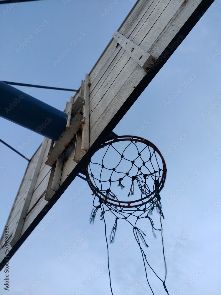 Wall mural basketball hoop against sky