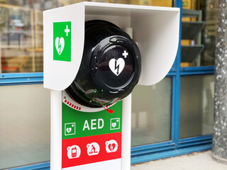 Automated external defibrillator AED as a service in front of an office building - 579633464