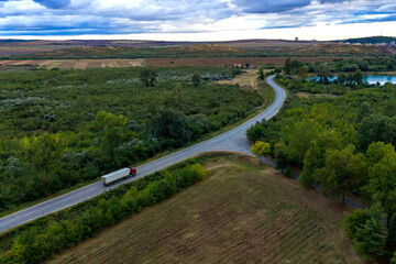 Fototapeta na wymiar Aerial view from a drone of a truck on road. Transportation and infrastructure concept