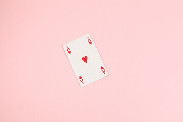 Poker playing cards on pink background