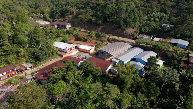 Aerial shot of La Conquista village, while the drone moves away revealing the landscape.
