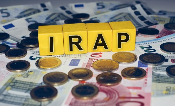 Euro banknotes and coins with the text &ldquo;IRAP&rdquo; Italian Tax