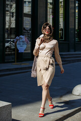 A girl in sunglasses walks the streets of the city