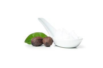 Shea nuts, leaf and spoon with Shea butter isolated on white background
