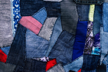 jeans fabric pieces sewn in different shapes and shades fragment, denim patchwork, needlework - obrazy, fototapety, plakaty