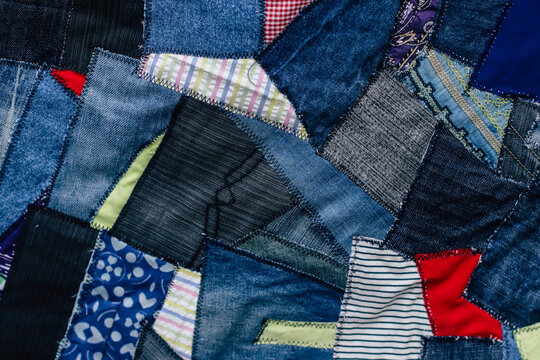 jeans fabric pieces sewn in different shapes and shades fragment, denim patchwork, needlework