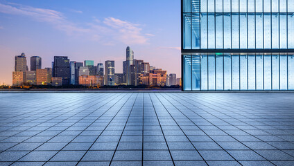 City Square floor and glass wall with modern city skyline at sunrise in Hangzhou, China.