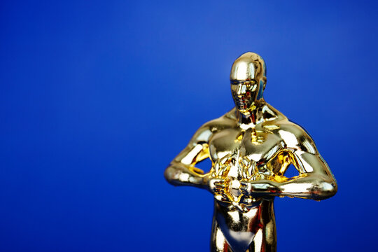 Oscar Award, Trophy Statue On Blue Background,copy Space