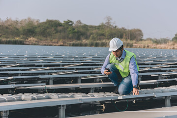 Fototapeta premium Male engineer installing or checking the working condition of solar panels on the roof or at the height of the factory for saving electricity was broken to use renewable energy from the sun