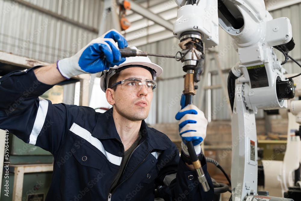 Leinwandbilder technician repair robotic arm in workshop. engineer maintenance automatic robotic arm machines in fa