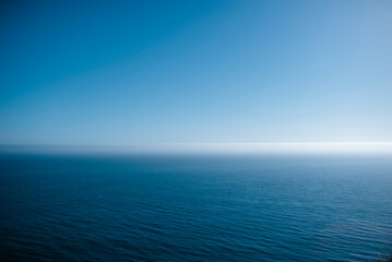 Tranquil view of calm sea against blue sky during summer