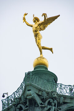 Low angle view of golden statue against clear sky in city