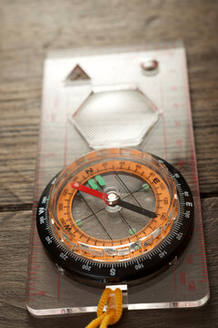 Close-up of navigational compass on wooden table