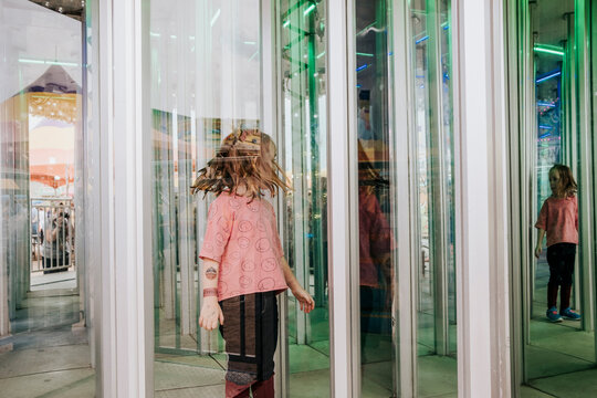 Girl seen through window at amusement park