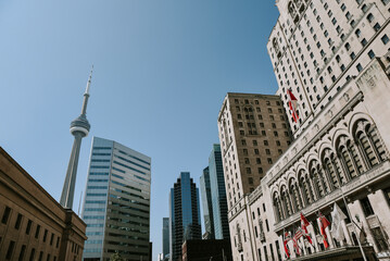 Low angle view of modern buildings against clear blue sky during sunny day