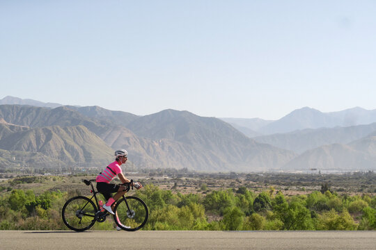 Cyclist taking a break in front of mountains