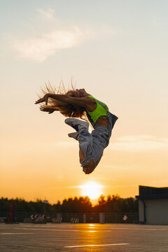 Woman jump against the background of a sunset.