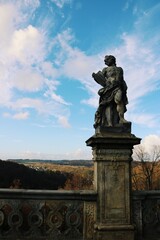 Obraz premium Unknown statue near the old castle.