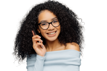 Portrait of satisfied African American woman talks on mobile phone, enjoys nice conversation, tells news to best friends, smiles broadly as hears funny story, isolated over blue background. Technology