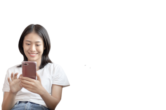 Asian woman sitting with smart phone on sofa in living room, Looking at tablet screen, Relaxing at home, Working through the Internet communication system, Happy working lifestyle.