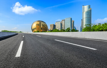Empty asphalt road and modern city skyline with buildings in Hangzhou, China.