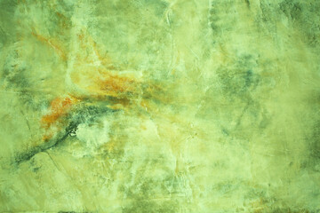 Green background from decorative plaster with abstract spots. Unusual green wall texture with beautiful patterns, creative surface background. Front covering for facing of buildings.