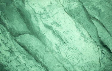 Green background from decorative plaster with abstract spots. Unusual green wall texture with beautiful patterns, creative surface background. Front covering for facing of buildings.