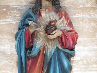 Statue of Christ Holding the Sacred Heart Detail at the San Crisogono Basilica in Rome, Italy