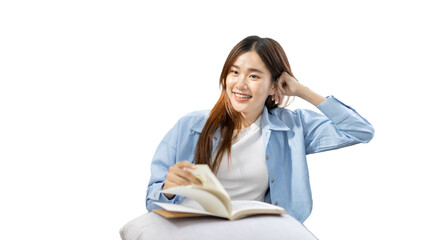 Asian woman reading a novel on the sofa in the living room,  Weekend leisure activities, happiness...