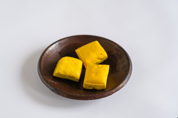 raw yellow tofu isolated white background