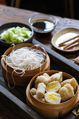empek-empek is Indonesian  fried fish cake., served with cuko (sour and spicy soup)