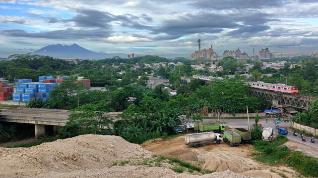 Panoramic view of dramatic morning sky above the cement factory, Salak Mount and the train to Nambo.