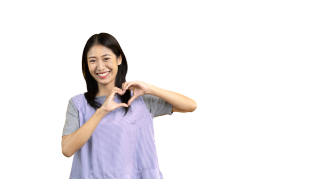 Asian young woman with bright smile making heart symbol shape with hands, Symbol of love and romance, Give each other cuteness and create smiles for each other, Positive thinking concept.