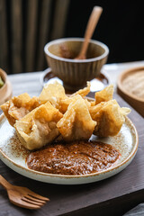 batagor is Indonesian dish like fried dumplings, served in peanut sauce and chili
