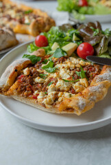 Turkish pide or flatbread with ground beef, vegetables and feta cheese