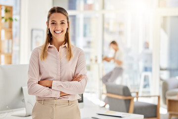 Fototapeta na wymiar Happy, business leader and woman with a smile in success with crossed arms in a light office. Portrait of a professional and confident white female employee in leadership and management at a company