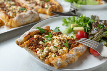 Turkish pide with mince meat, vegetable, feta cheese topping
