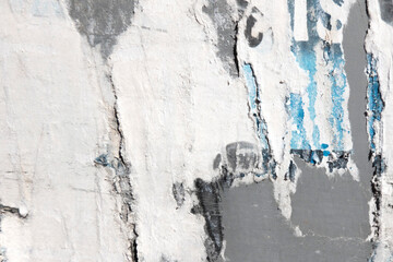 Old grunge torn collage urban street posters creased crumpled paper placard texture background. Ripped faded paper backdrop surface placard
