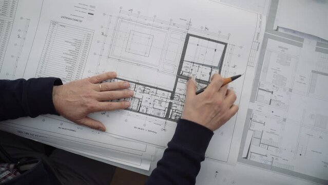 Architects collaborate on precise planning and creative problem-solving. Watch our team deliver innovative solutions with blueprints. Ideal for design and engineering projects.