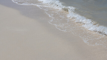 beautiful view, close-up of crystal clear sand and water in the sea, surf on a sunny day,